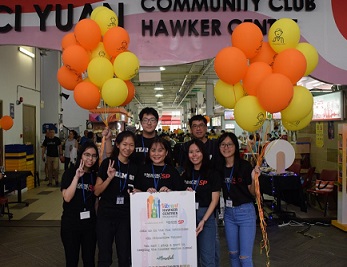 DEPM team posing at Ci Yuan Hawker Centre, with customised balloons