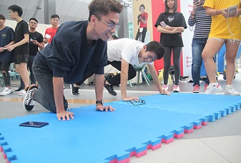 Attendees doing push ups at the Fitness Challenge