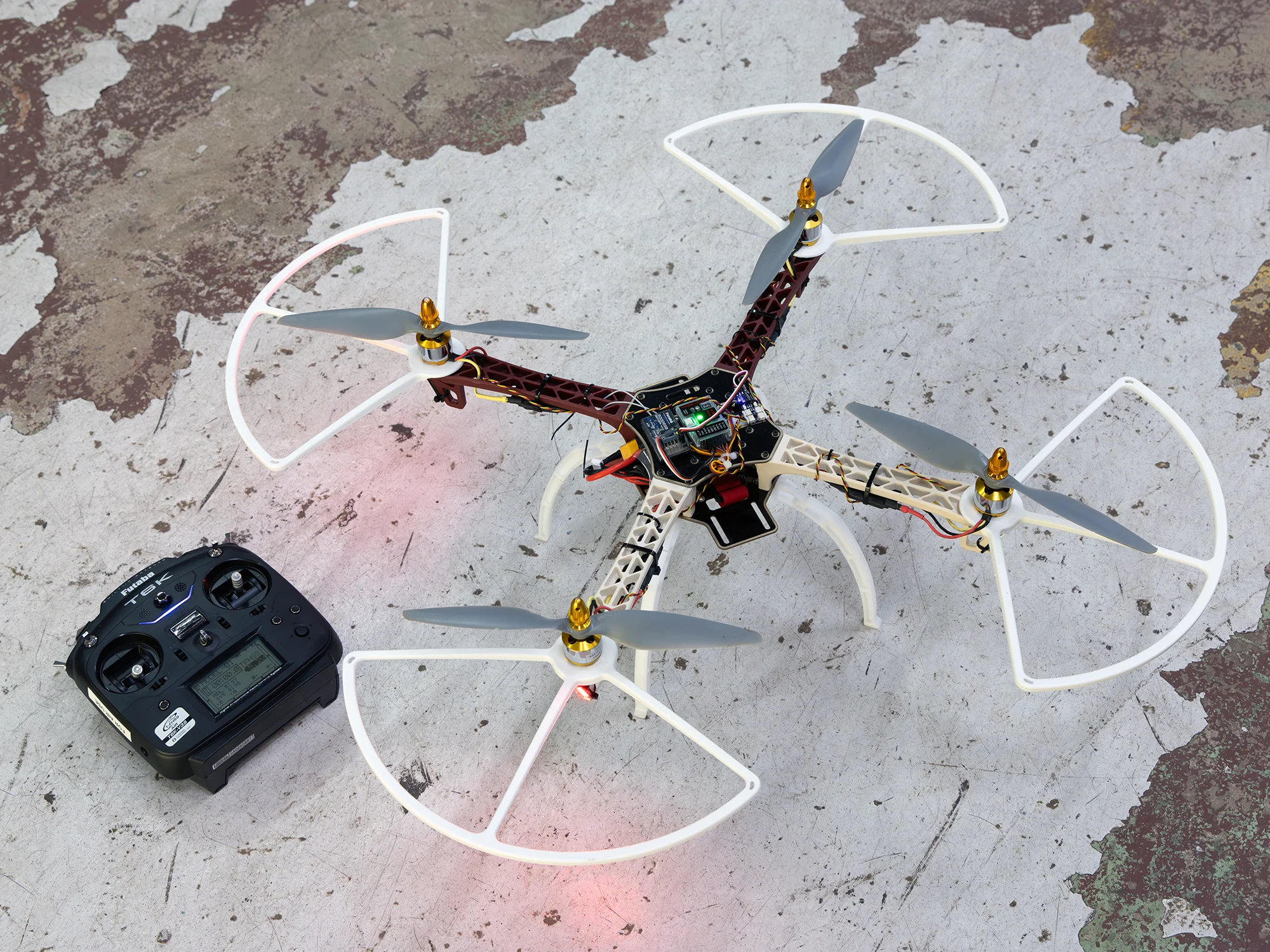 A quadcopter drone designed for search-and-rescue missions involving lifebuoy deployment.