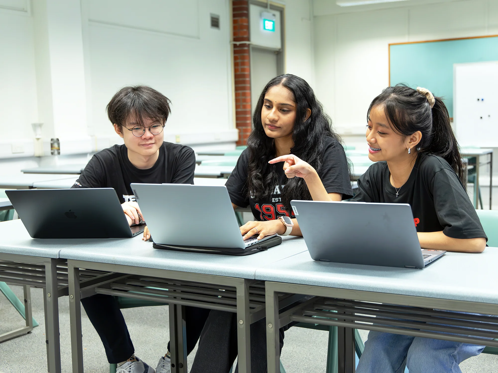 Students collaborating on an innovative SIWMA project, fostering teamwork and creativity.