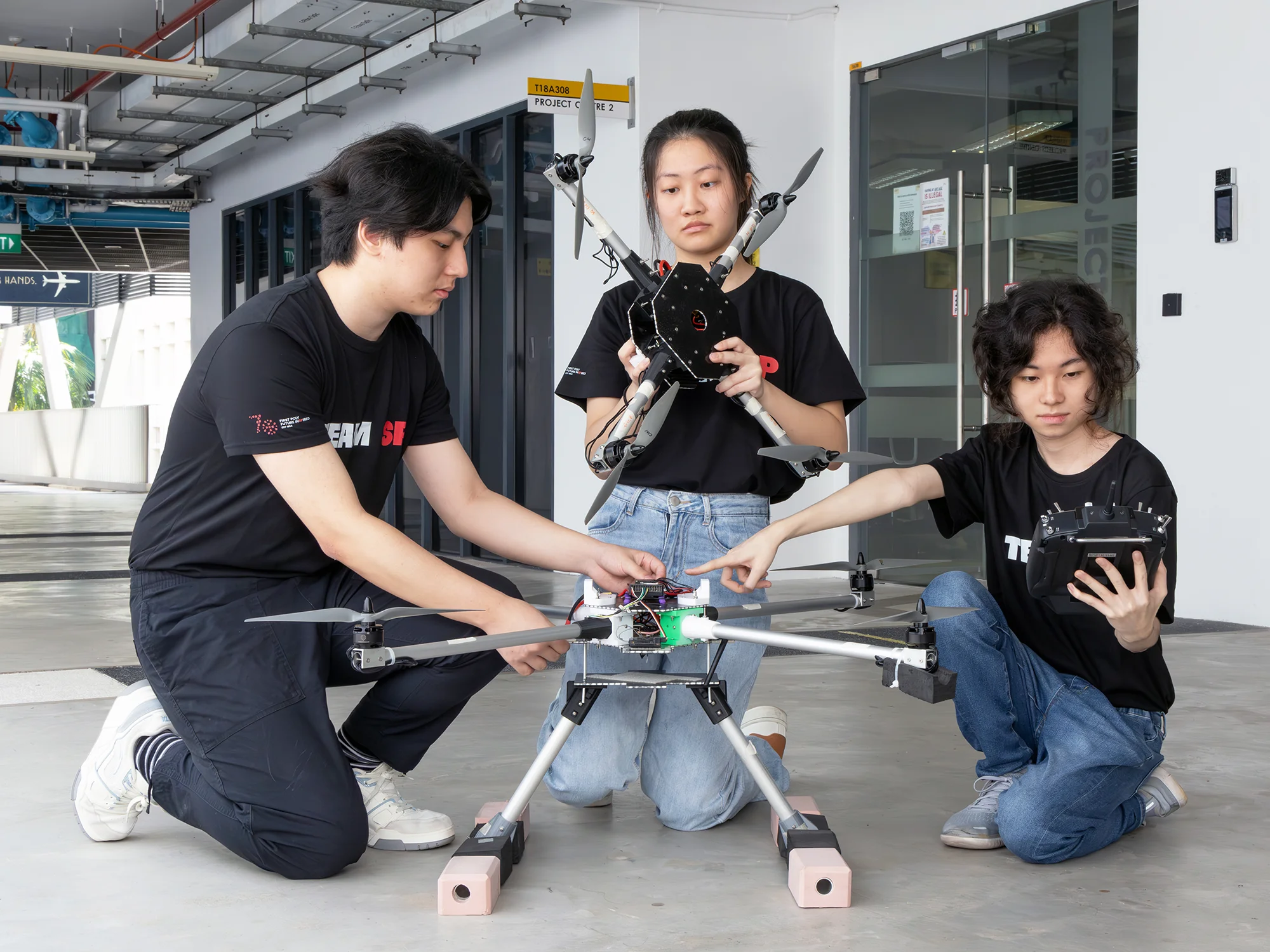 Students preparing the UAS for flight, from 4-rotor configuration to 8-rotor configuration.