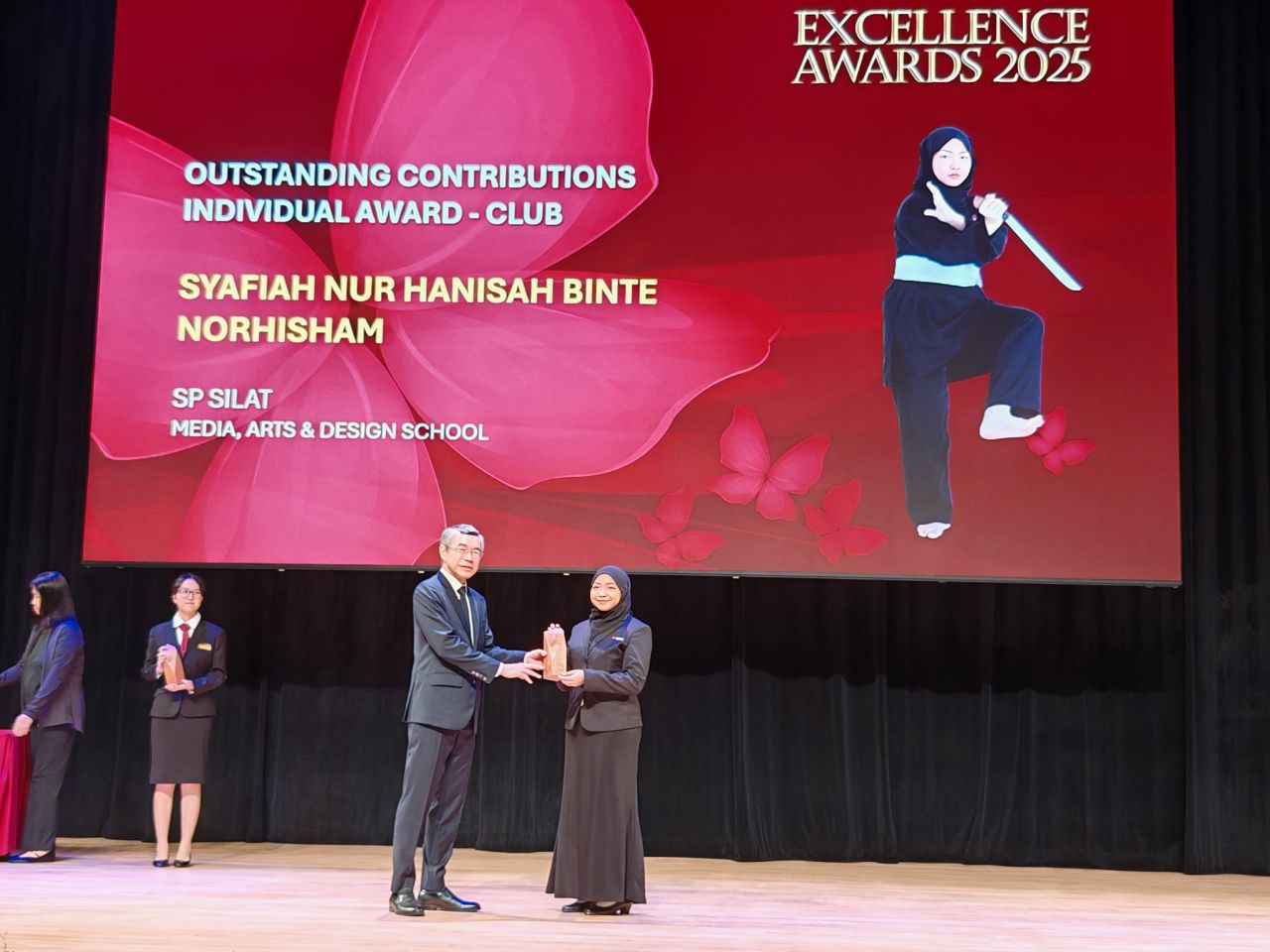 Syafiah Nur Hanisah Binte Norhisham receiving award from PCEO