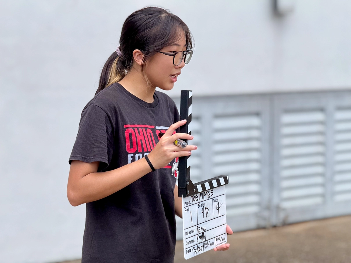 woman with a production clapper board