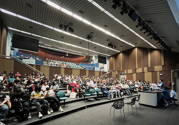students attending talk in a hall