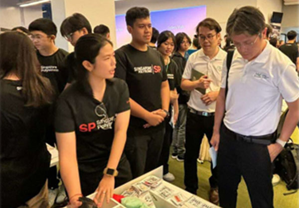 Students Explaining their projects to visitors of their booth