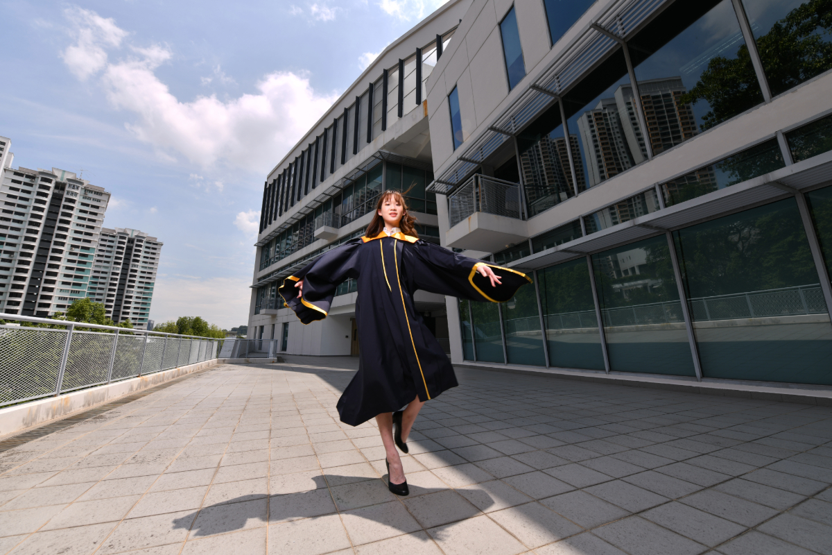 SP-DBA Student Skipping in Grad Gown-v01