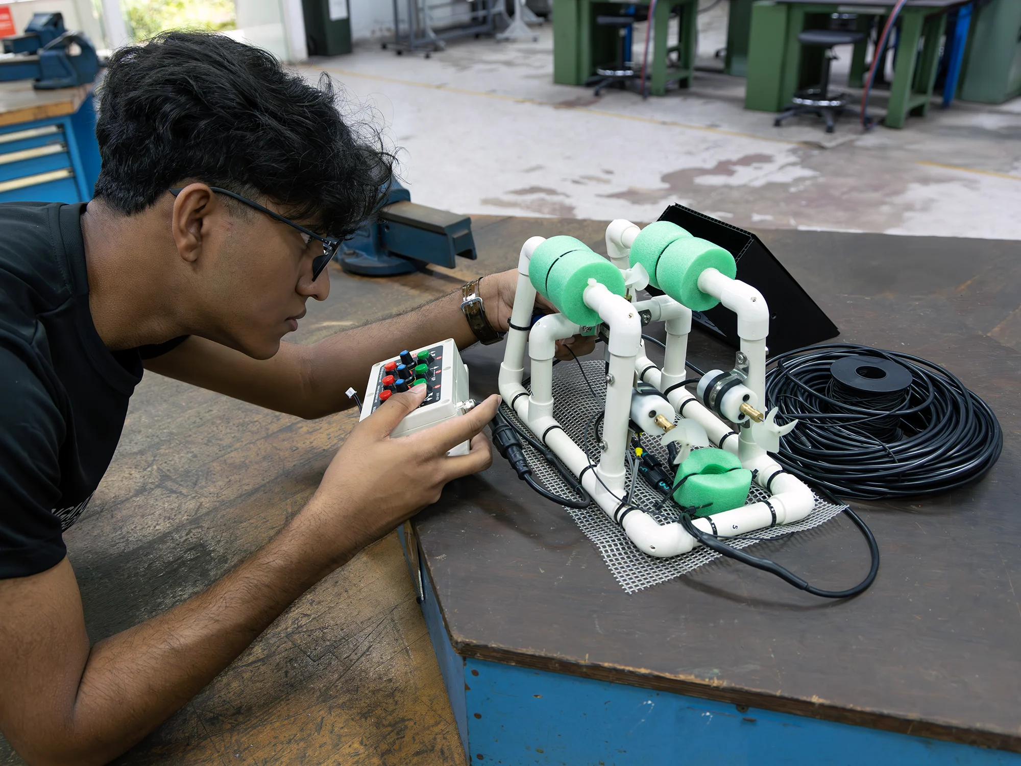Student is calibrating the device, focusing on the control box, featuring colored buttons.