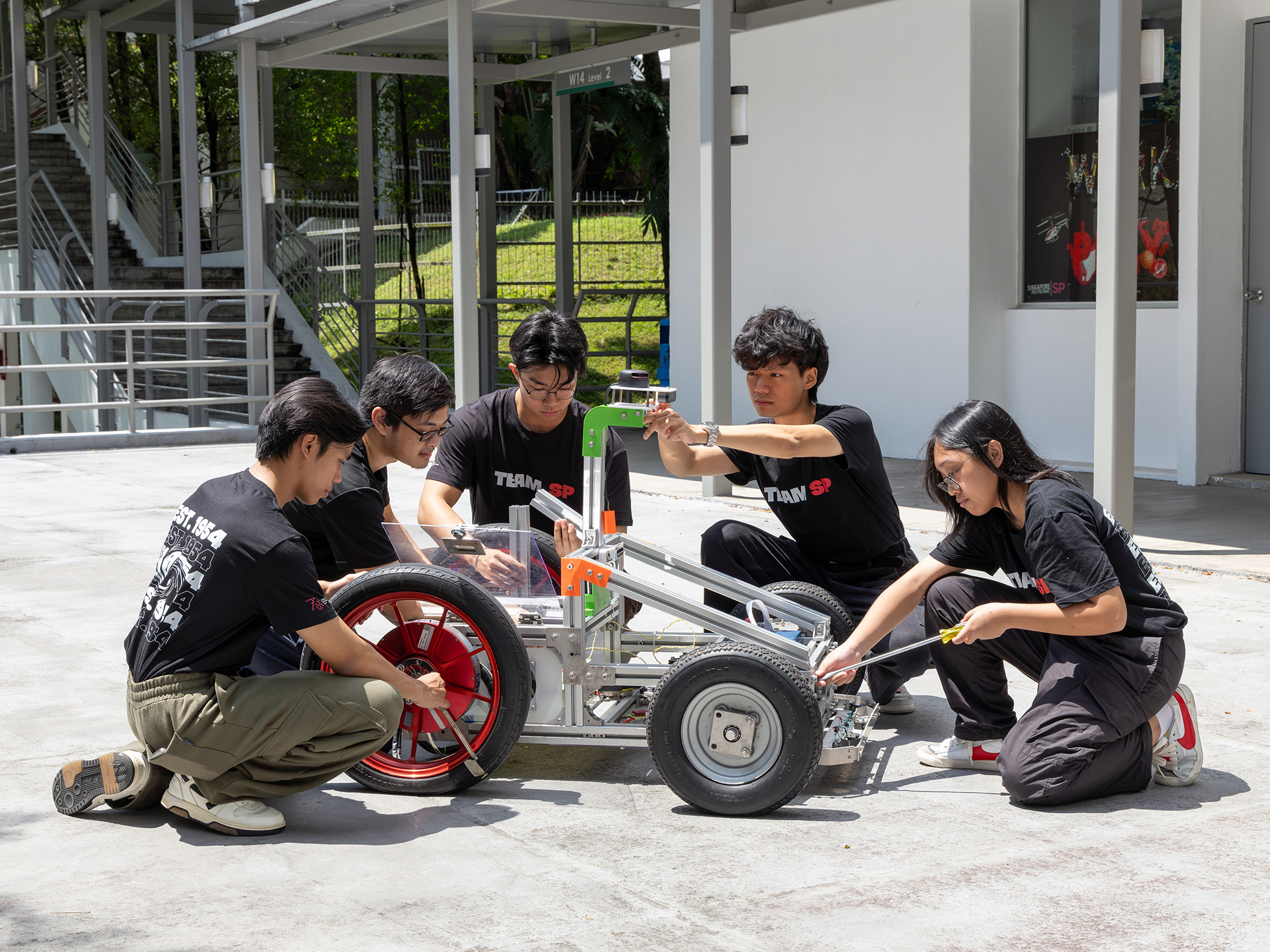 Students troubleshooting the Mini Electric Vehicle