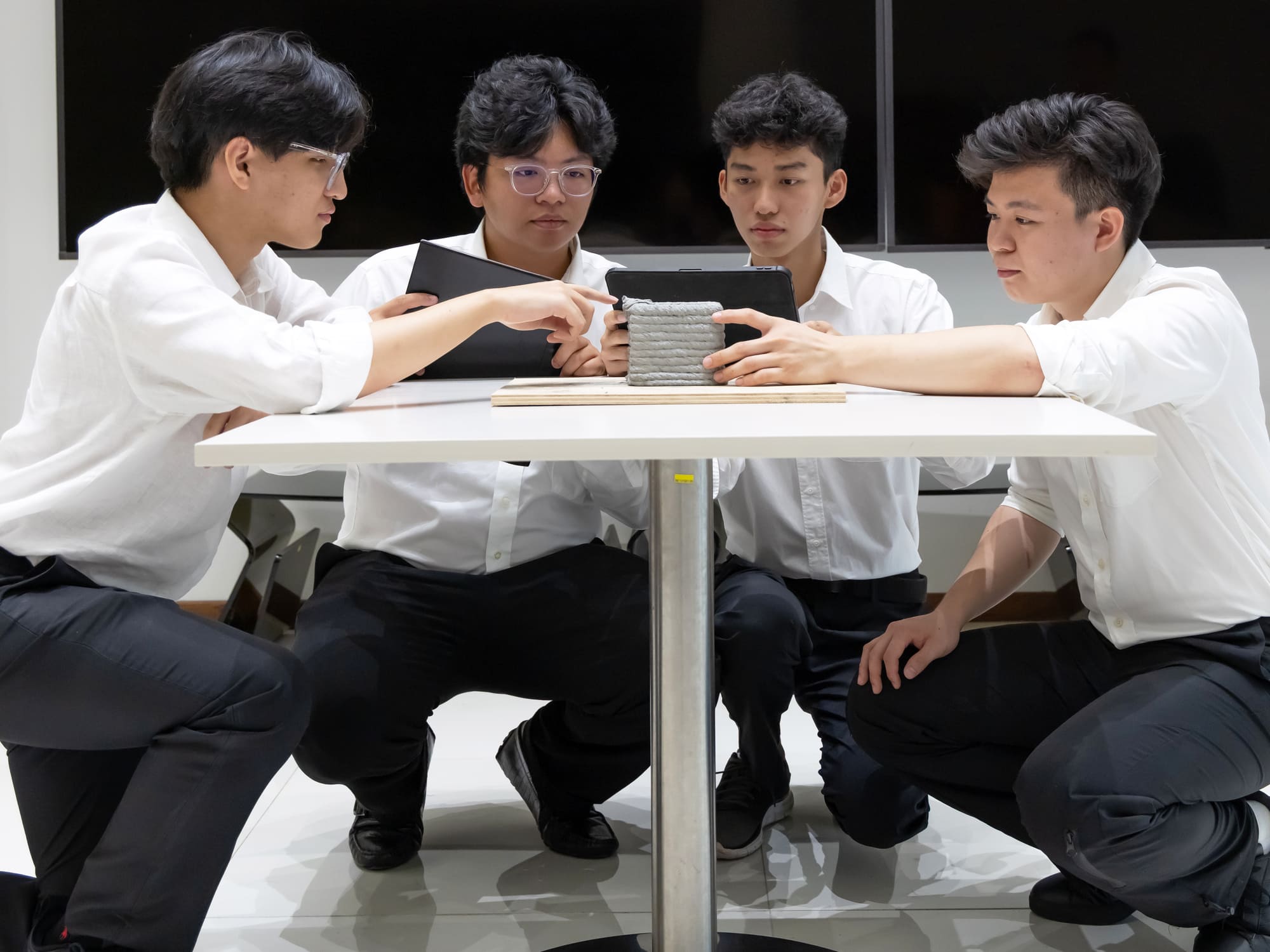 FYP team examining a 3D-printed sawdust–cement composite for green building applications