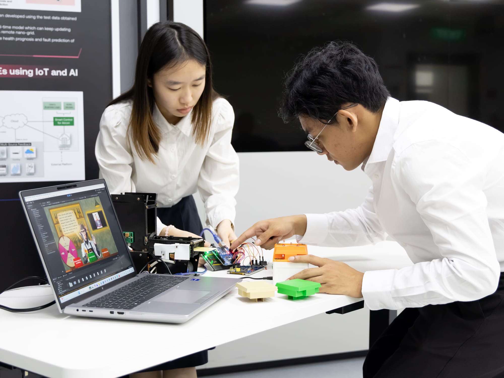 Student is calibrating the device, focusing on the control box, featuring colored buttons.